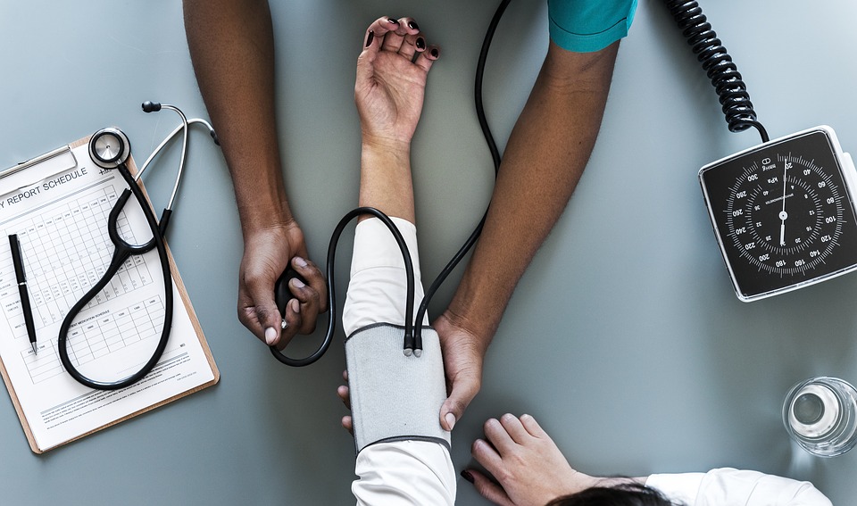 Hands of nurse and patient during blood pressure