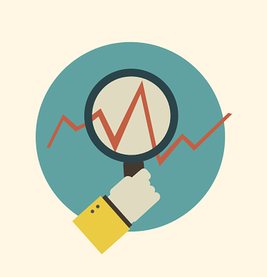 Mano sujetando una lupa a través de la cual se observa una línea de tendencia