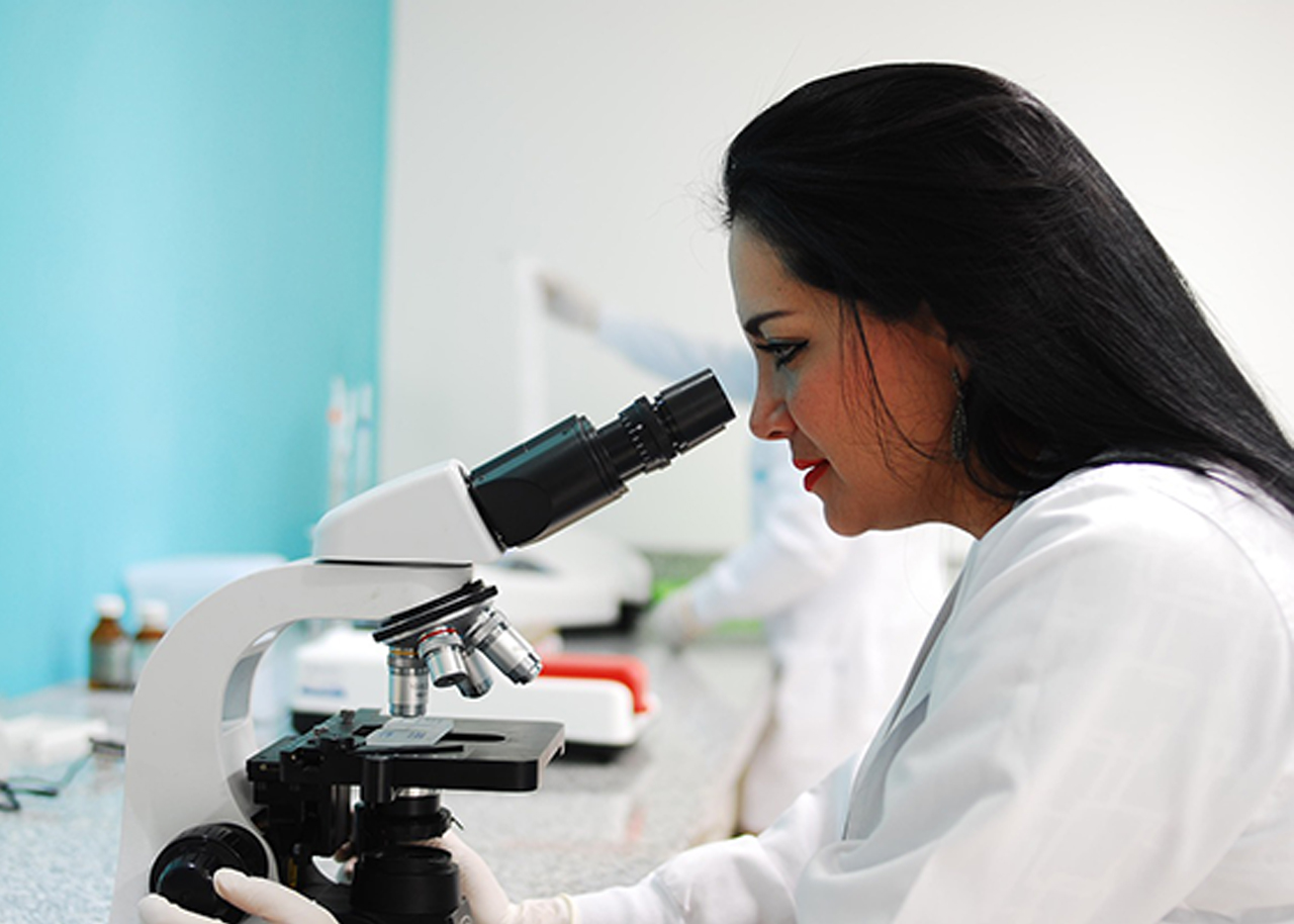 Científica con microscopio.