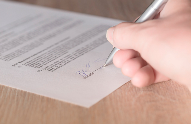 Persona firmando contrato de trabajo